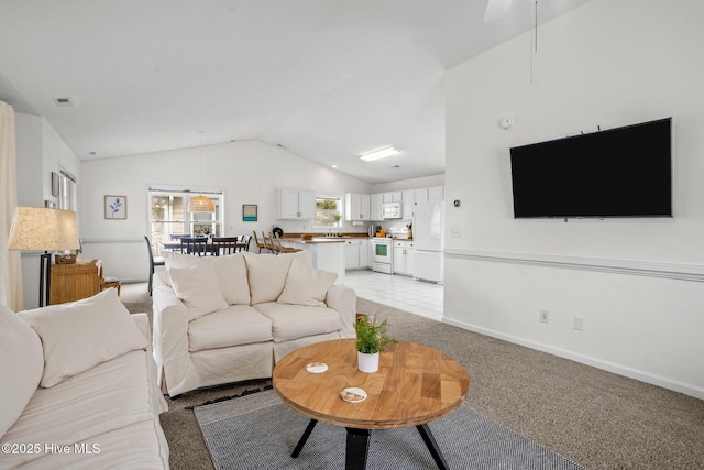 carpeted living room with vaulted ceiling