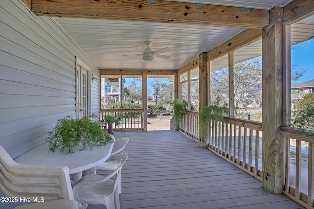 unfurnished sunroom featuring a wealth of natural light and a ceiling fan