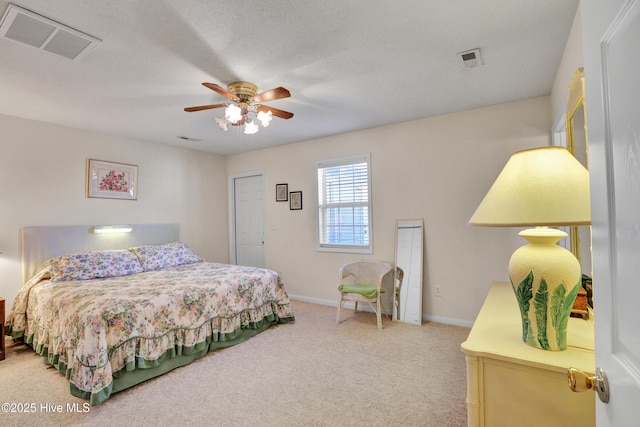 bedroom featuring visible vents, light colored carpet, a ceiling fan, and baseboards