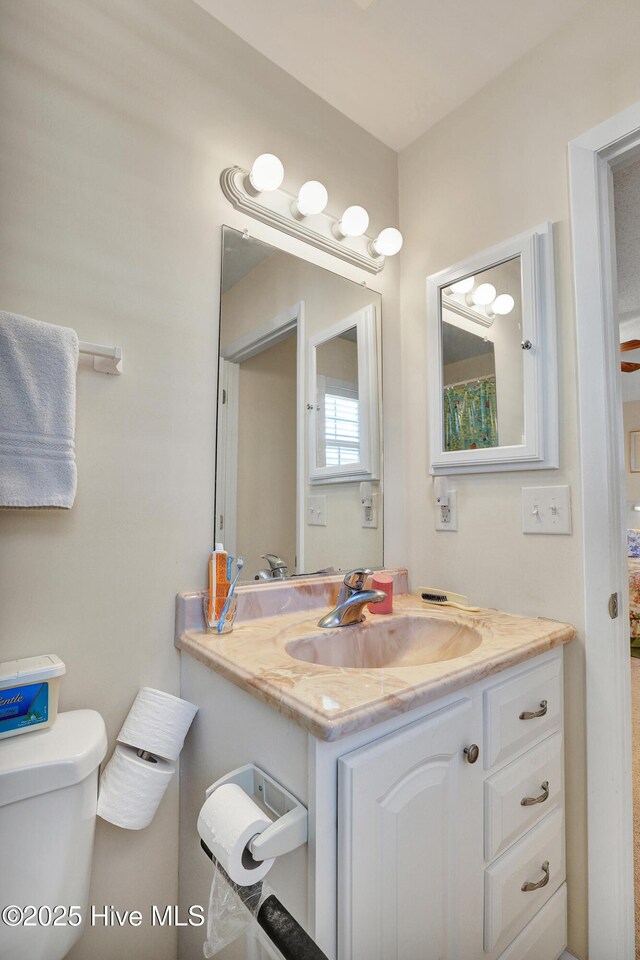 washroom featuring stacked washer / dryer, light tile patterned floors, and cabinets