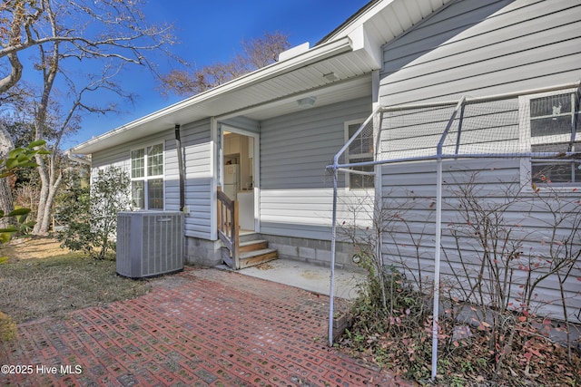 entrance to property featuring a patio area and central AC