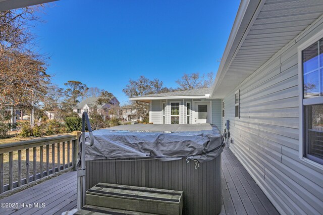 wooden terrace featuring a hot tub