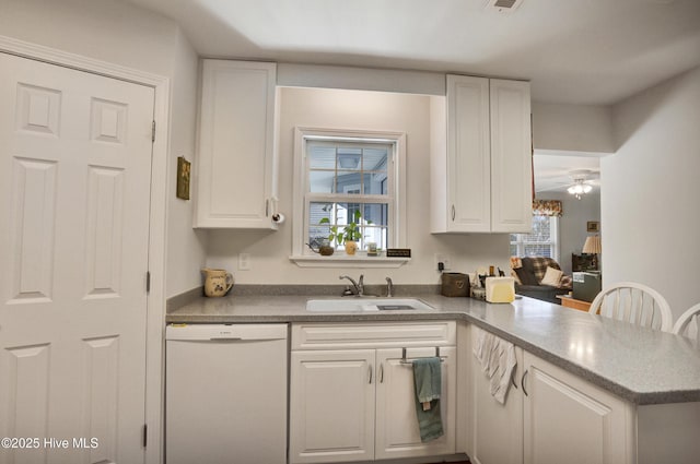 kitchen with white dishwasher, white cabinetry, kitchen peninsula, and ceiling fan