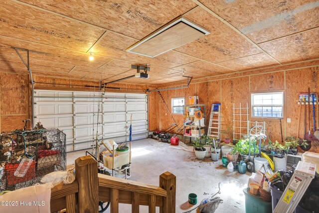 garage featuring wood walls and a garage door opener