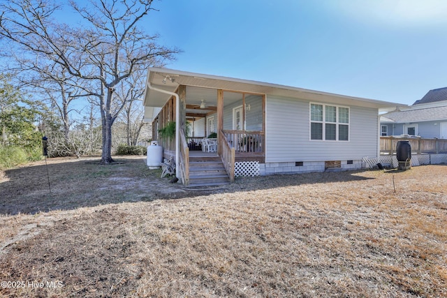 view of front facade with ceiling fan, a porch, and crawl space