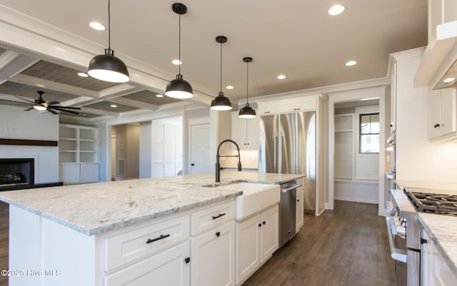 kitchen featuring white cabinets, an island with sink, coffered ceiling, and appliances with stainless steel finishes