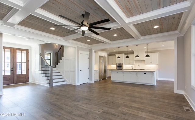 unfurnished living room with crown molding, french doors, beamed ceiling, and coffered ceiling