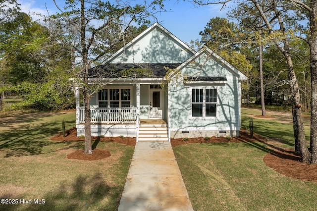 view of front of home featuring crawl space, a front lawn, and covered porch