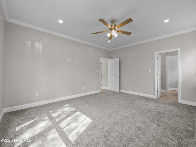 spare room featuring crown molding, ceiling fan, and carpet floors