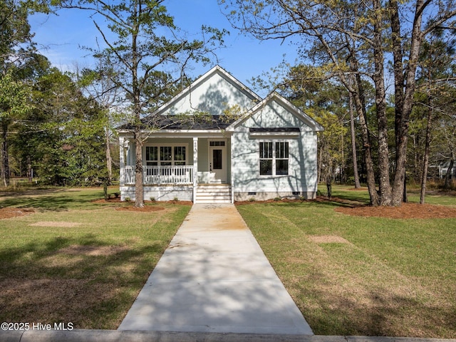 view of front of house featuring crawl space, covered porch, and a front yard