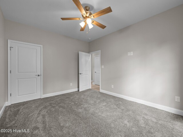 unfurnished bedroom with carpet, baseboards, and a ceiling fan