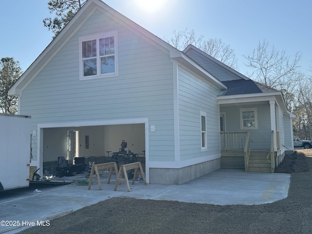 exterior space featuring an attached garage and a patio area