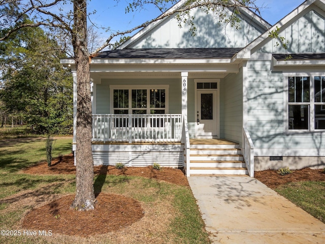 view of front facade with board and batten siding, a porch, a shingled roof, and crawl space