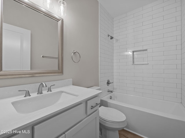 full bath with toilet, vanity, and bathtub / shower combination