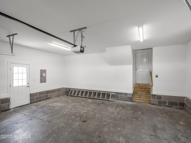 garage with electric panel and a garage door opener
