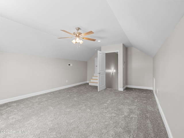 additional living space with carpet, baseboards, a ceiling fan, and vaulted ceiling