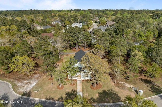 aerial view featuring a wooded view