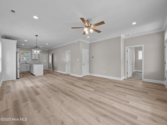 unfurnished living room featuring visible vents, baseboards, light wood finished floors, and plenty of natural light
