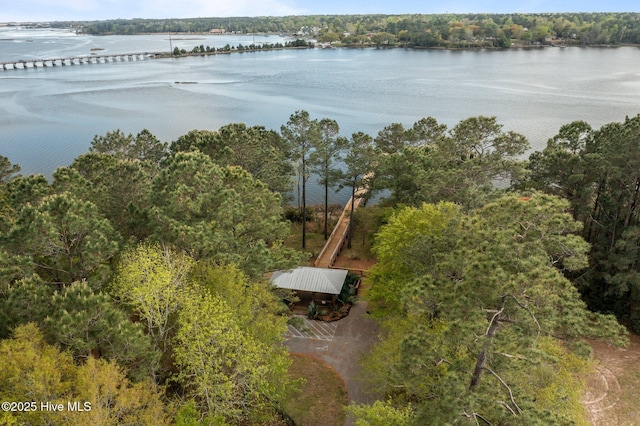 birds eye view of property featuring a wooded view and a water view