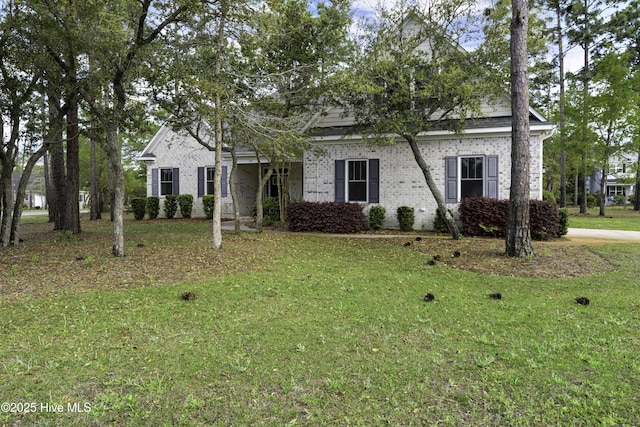 view of front of home with a front lawn and brick siding