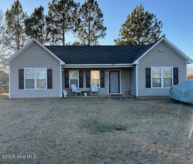 ranch-style home with a front lawn