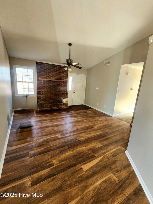 unfurnished living room with ceiling fan, dark hardwood / wood-style flooring, and vaulted ceiling