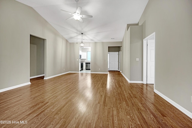 unfurnished living room featuring ceiling fan, wood-type flooring, and lofted ceiling