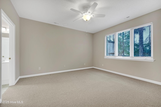 unfurnished room with ceiling fan and carpet floors