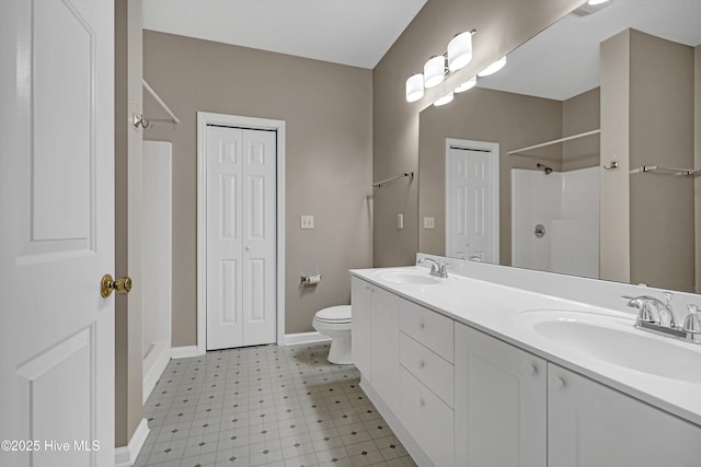 bathroom featuring walk in shower, vanity, and toilet