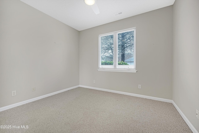 empty room with ceiling fan and carpet floors