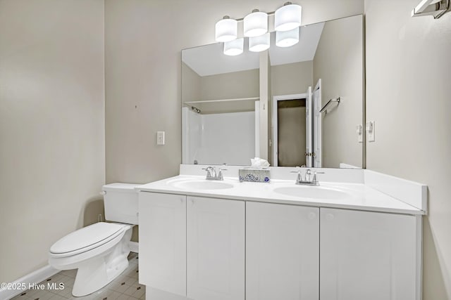 bathroom with walk in shower, vanity, tile patterned floors, and toilet