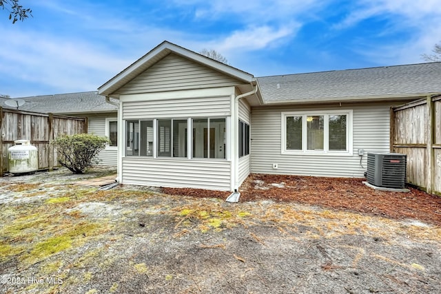 back of house with cooling unit and a sunroom