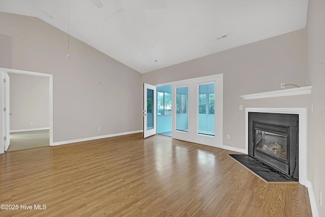 unfurnished living room with lofted ceiling and hardwood / wood-style floors