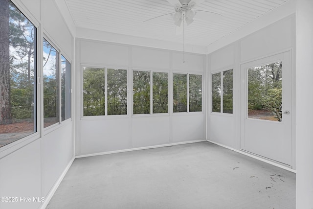 unfurnished sunroom with ceiling fan