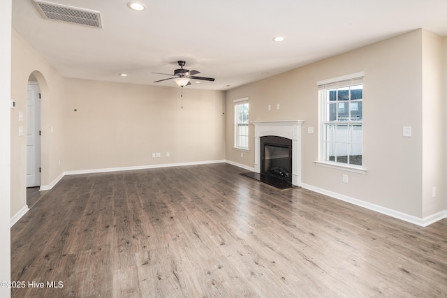 unfurnished living room featuring hardwood / wood-style floors and ceiling fan