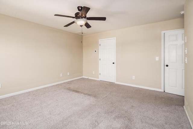 spare room featuring carpet floors and ceiling fan