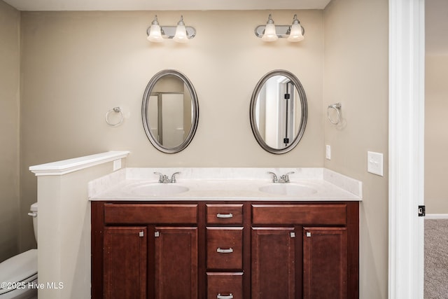 bathroom featuring vanity and toilet