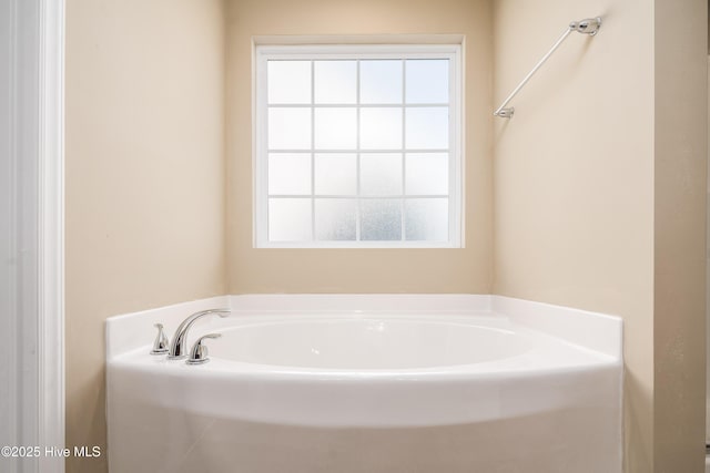 bathroom with a bathtub and plenty of natural light