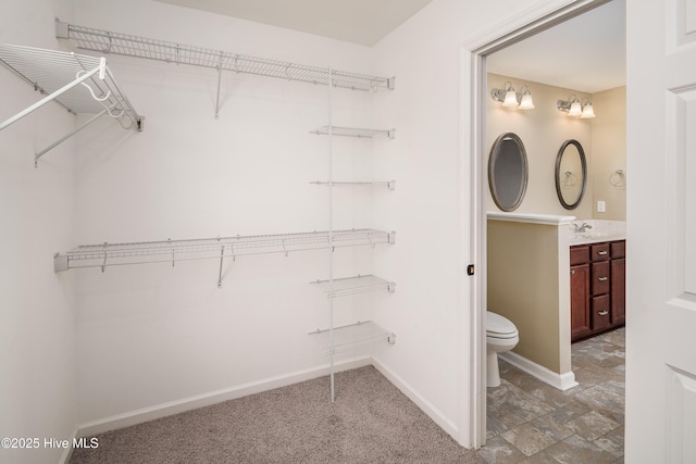 walk in closet featuring sink