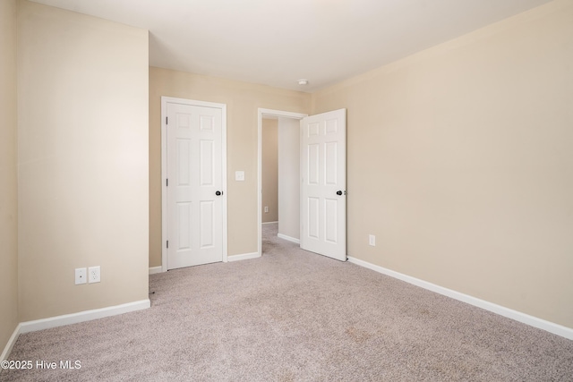 unfurnished room with light carpet