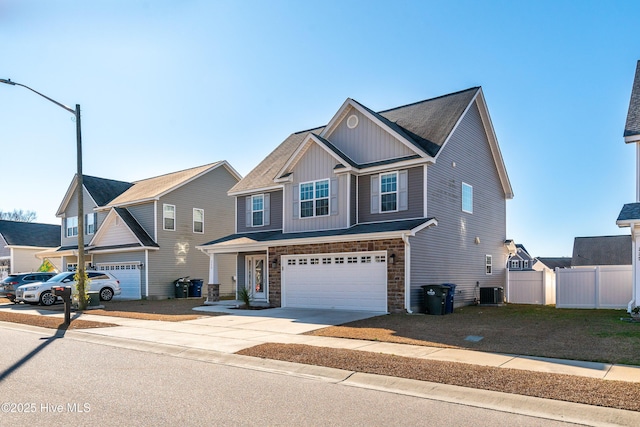 view of front of home with central AC unit and a garage