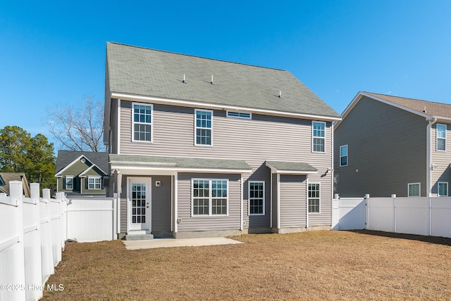 rear view of property with a patio area and a yard