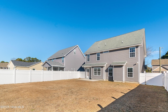 back of house with a lawn