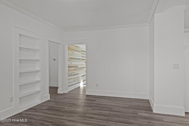 empty room with ceiling fan, ornamental molding, wood walls, and wood-type flooring