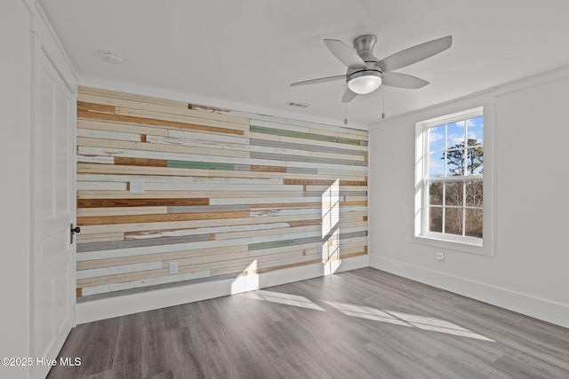 unfurnished room with ceiling fan and hardwood / wood-style floors