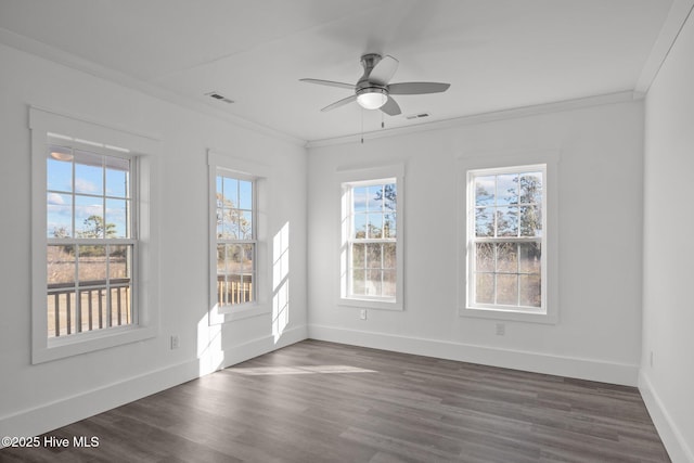 empty room featuring dark wood-type flooring, crown molding, and ceiling fan