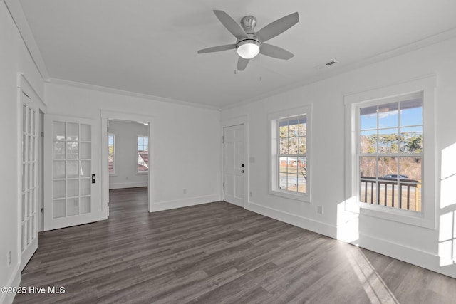 spare room with dark hardwood / wood-style flooring, ornamental molding, and plenty of natural light