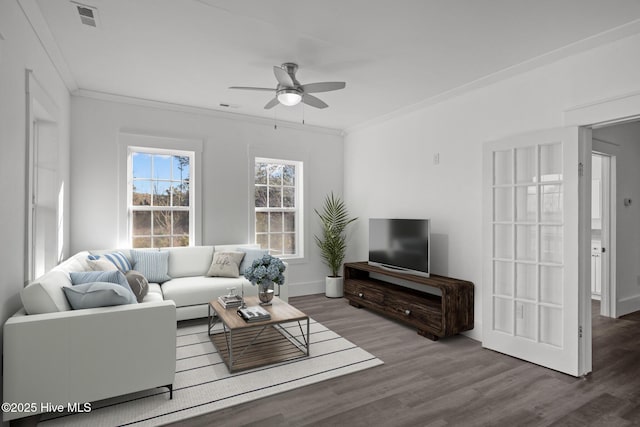 living room with ornamental molding, ceiling fan, and wood-type flooring