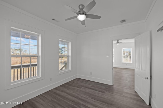 unfurnished room featuring ornamental molding, dark wood-type flooring, and ceiling fan