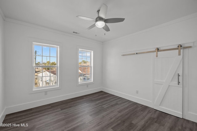 empty room featuring ceiling fan, ornamental molding, and dark wood-type flooring